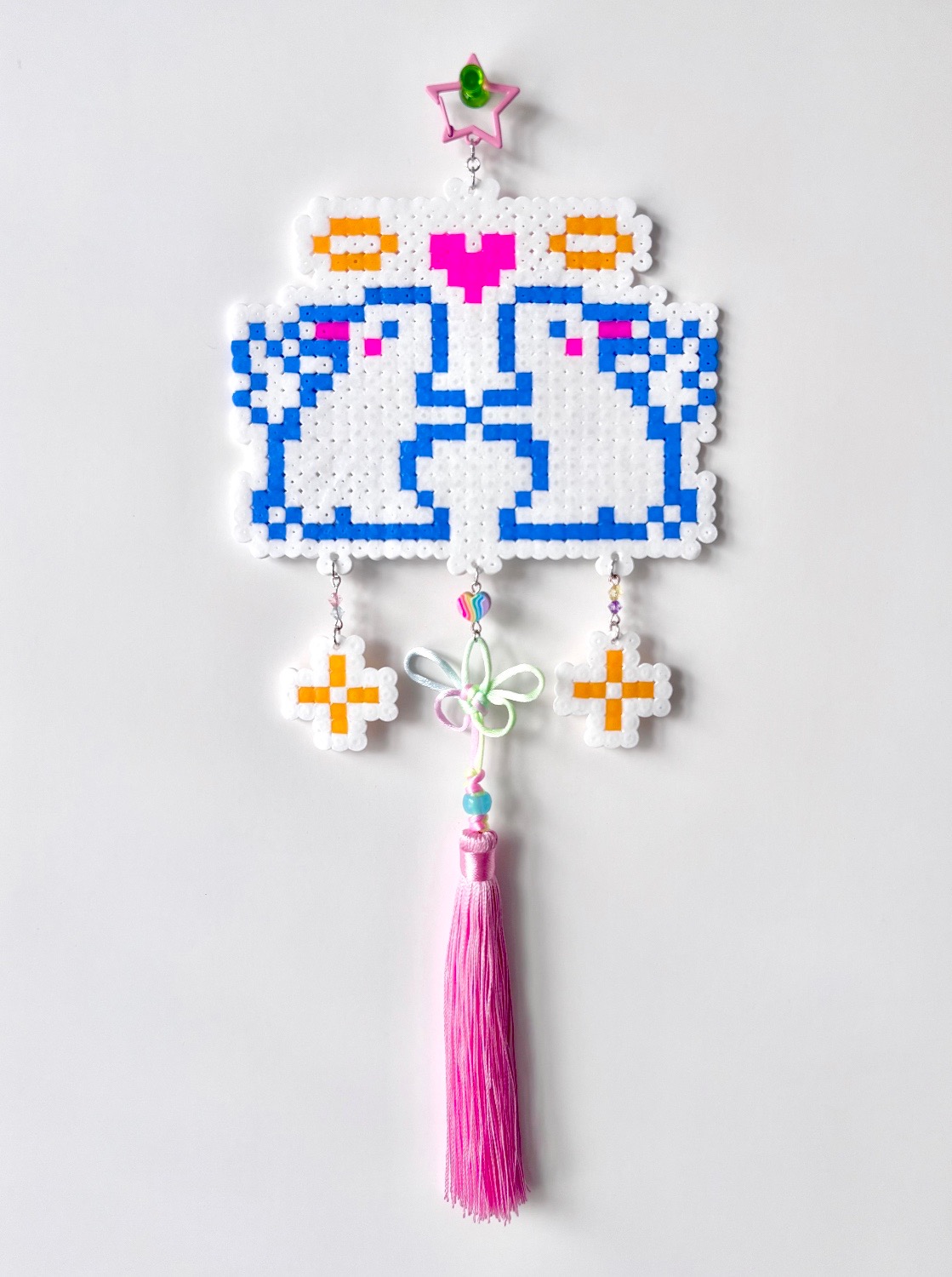 Didi (Digital Deity): a small white gacha machine filled with plastic capsules, displayed on a plinth in front of a bookshelf.