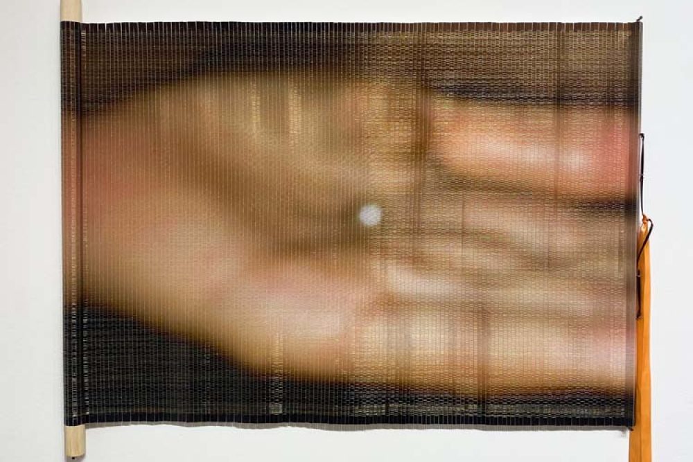 Tong Zhou Lafrane, Tong Zhou Lafrance, Untitled Labour: Golden Pearl 2012, 2022. Photo paper woven with sewing metallic threads, supported with wooden dowels, 20” x 30”. Image courtesy of the artist.